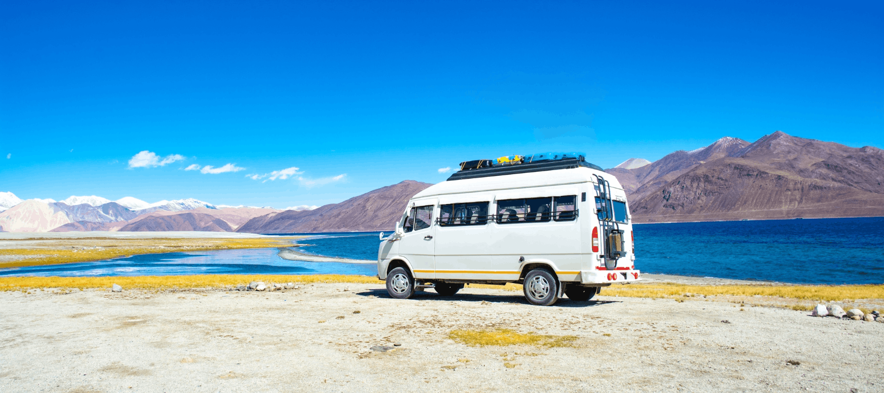 SKG Travels tempo traveller beside Pangong lake